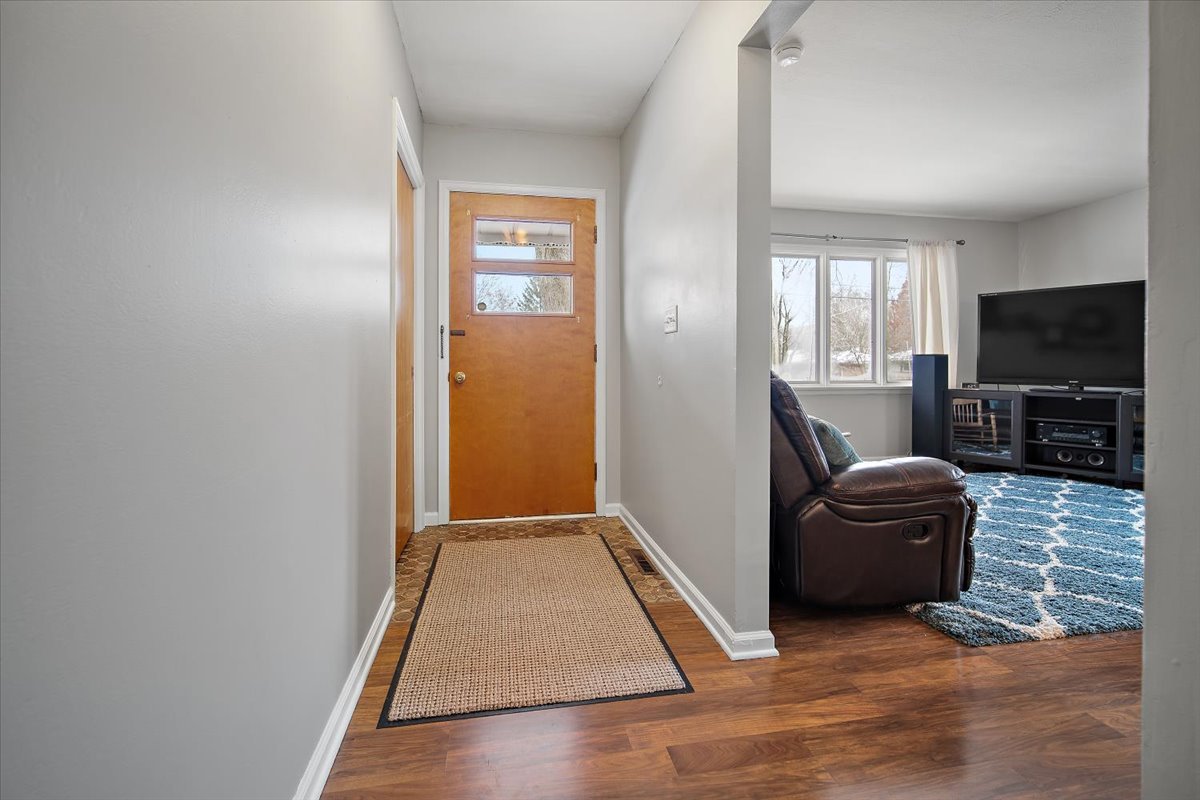 203 South Cottage Avenue Normal, IL 61761 - Photo 4 of 25 a hallway with a couch and a flat screen tv