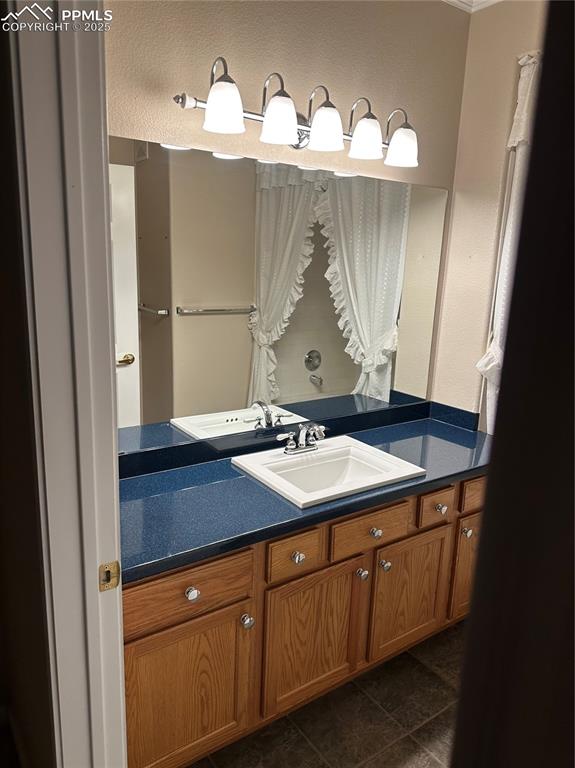 3748 Riviera Grove, Unit 101 Colorado Springs, CO 80922 - Photo 5 of 19 a bathroom with a sink and a mirror