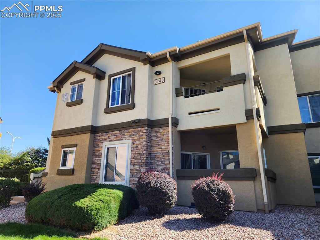 3748 Riviera Grove, Unit 101 Colorado Springs, CO 80922 - Photo 10 of 19 a front view of a house with a yard