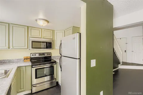 a white refrigerator freezer sitting in a kitchen