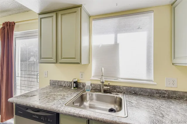 a kitchen with granite countertop a sink and a window