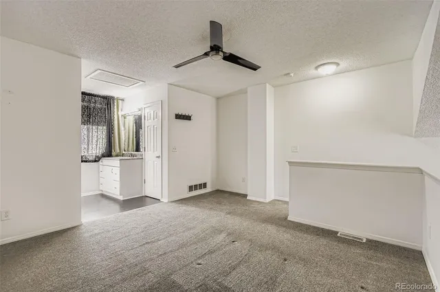 an empty room with closet and windows