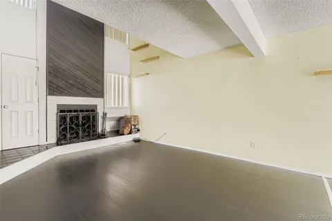 a view of an empty room with a fireplace