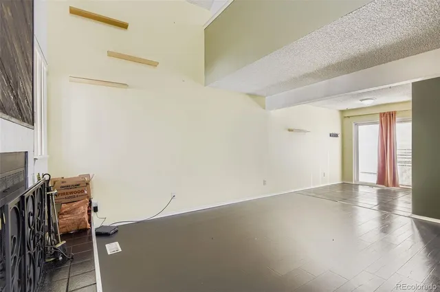 a view of a workspace with furniture and a bookshelf