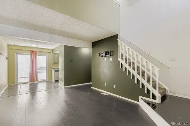 a view of an entryway with wooden floor