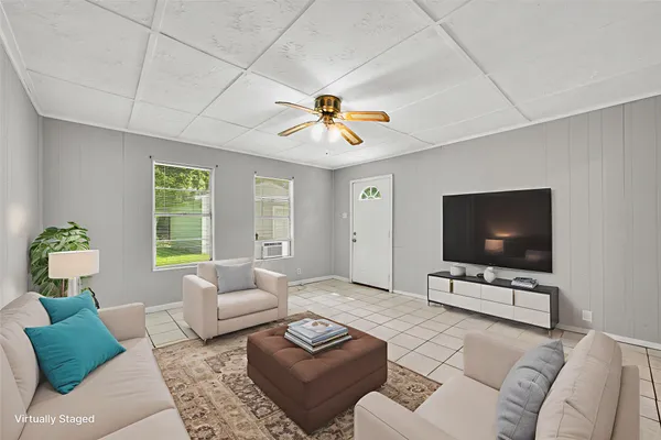 a living room with furniture and a flat screen tv