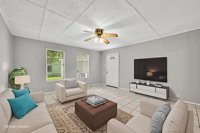 a living room with furniture and a flat screen tv