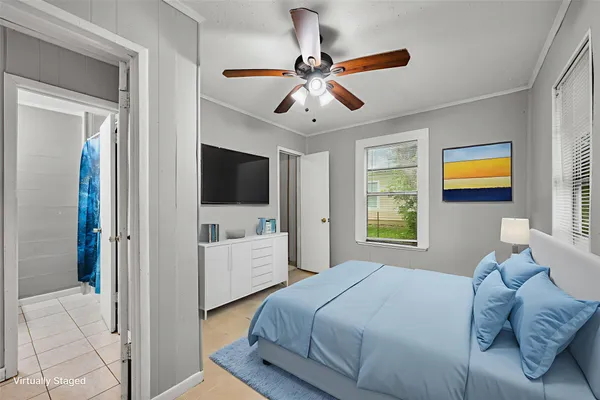 a bedroom with a bed and a flat screen tv