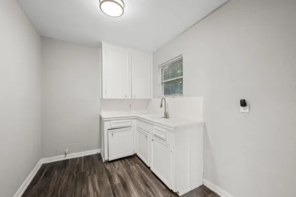 a room with a sink and cabinets