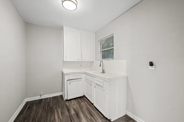 a room with a sink and cabinets