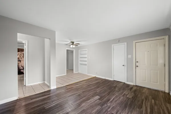 a view of a room with wooden floor and entryway