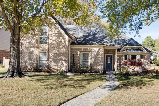 a view of a house with snow on the tree