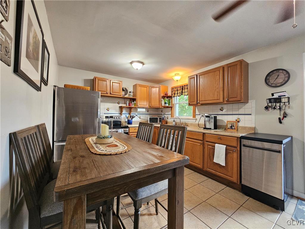 210 Easton Road Riegelsville, PA 18077 - Photo 3 of 39 a kitchen with stainless steel appliances granite countertop a stove a sink dishwasher a dining table and chairs with wooden floor