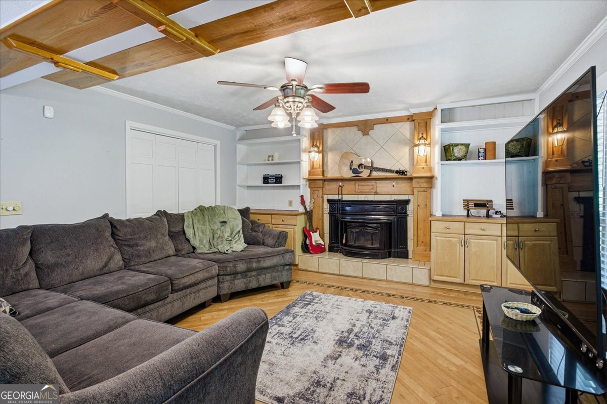 3270 Rex Road Rex, GA 30273 - Photo 14 of 35 a living room with furniture a flat screen tv and a fireplace