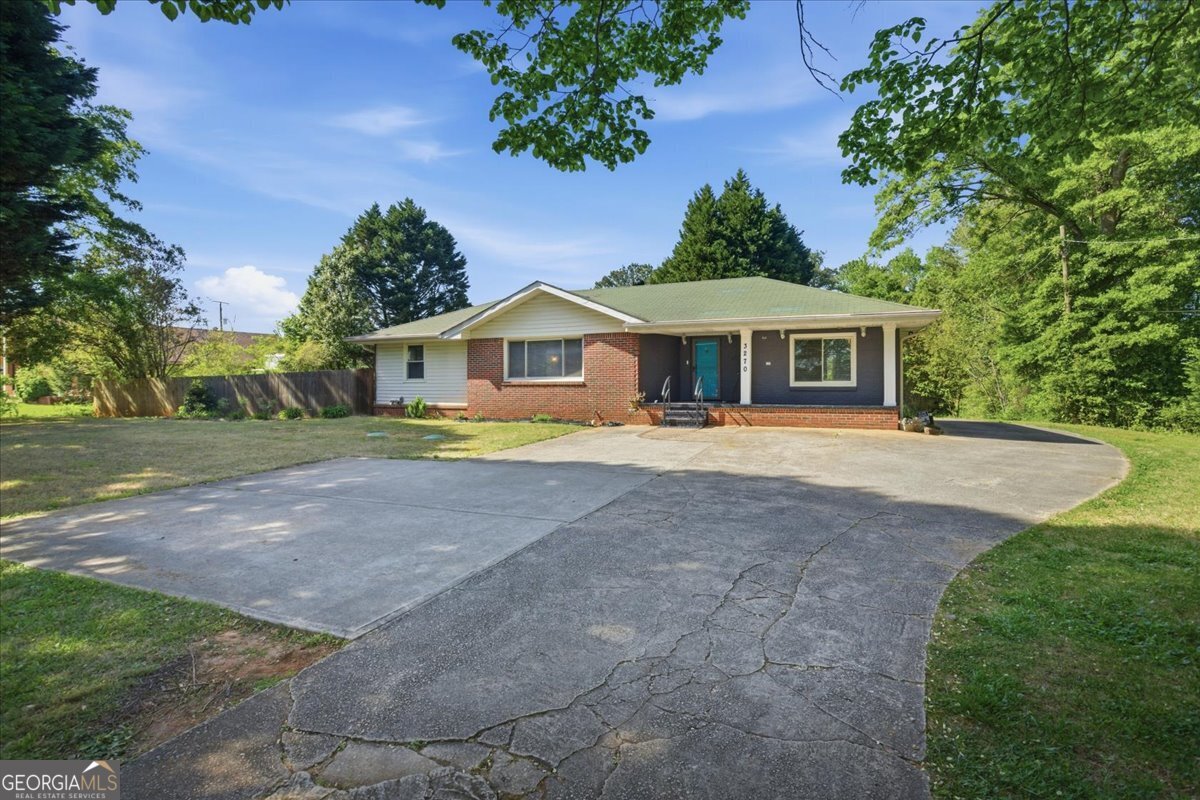 3270 Rex Road Rex, GA 30273 - Photo 26 of 35 a front view of a house with a yard and green space