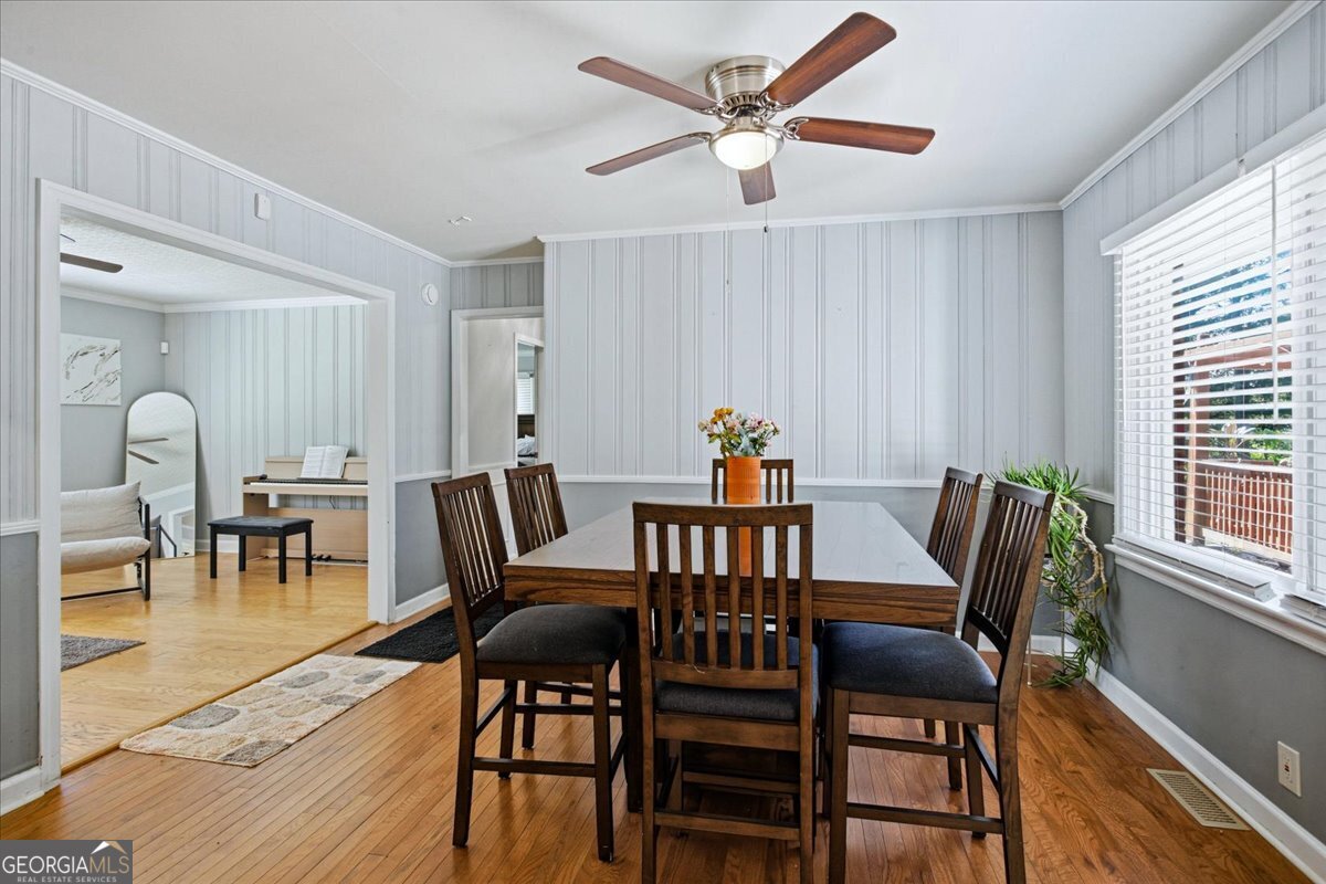 3270 Rex Road Rex, GA 30273 - Photo 7 of 35 a dining room with furniture a window and wooden floor