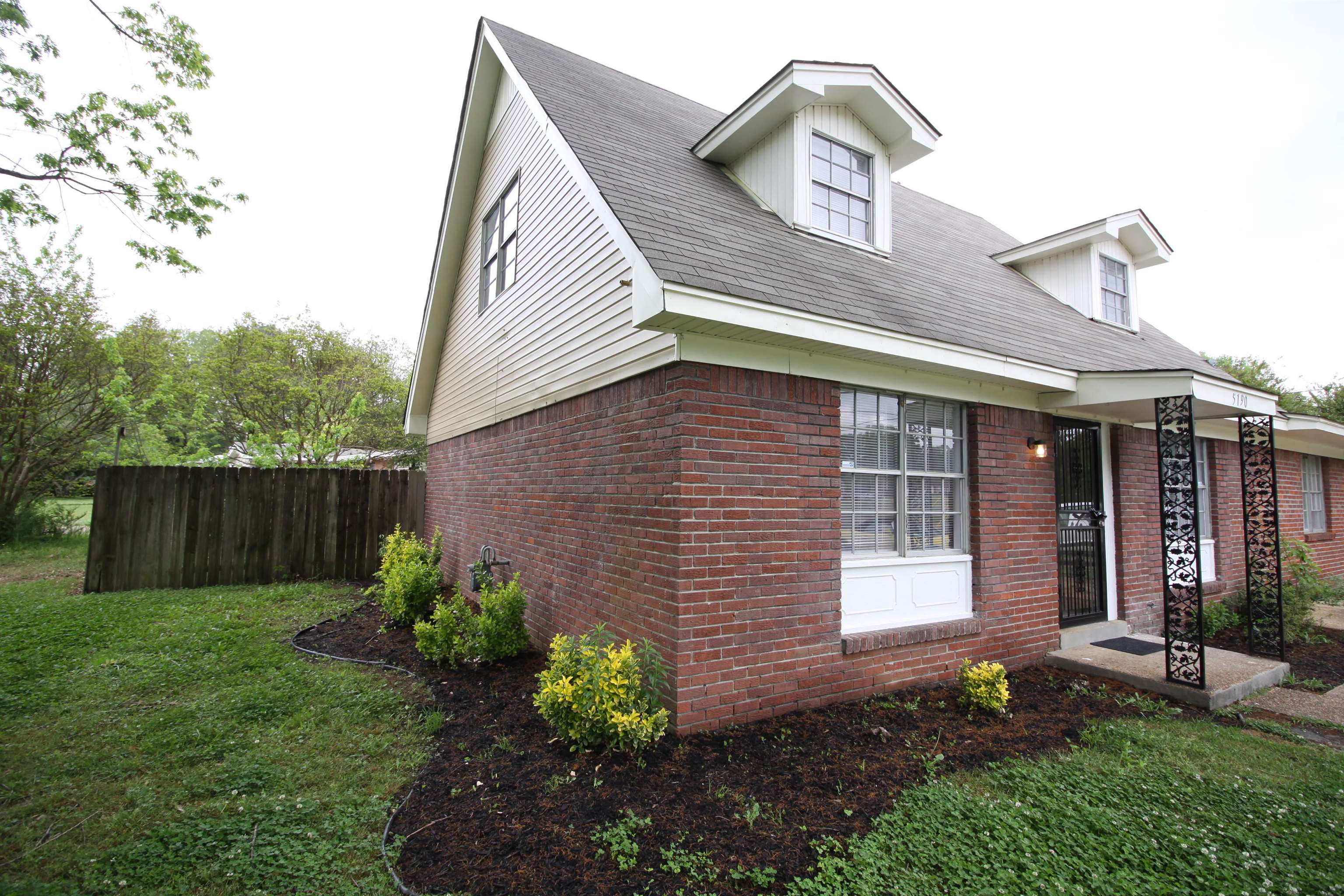 5190 Cottonwood Road Memphis, TN 38118 - Photo 5 of 26 a front view of a house with garden