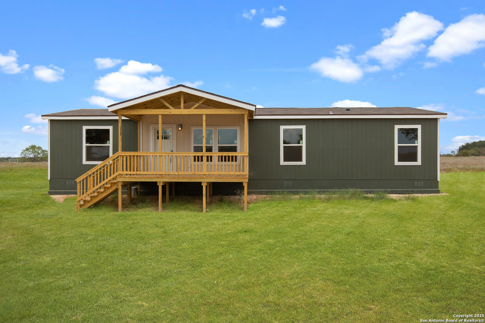 a view of a house with yard and sitting area