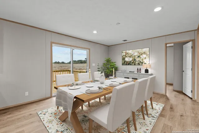 a kitchen with a sink a stove a refrigerator and white cabinets