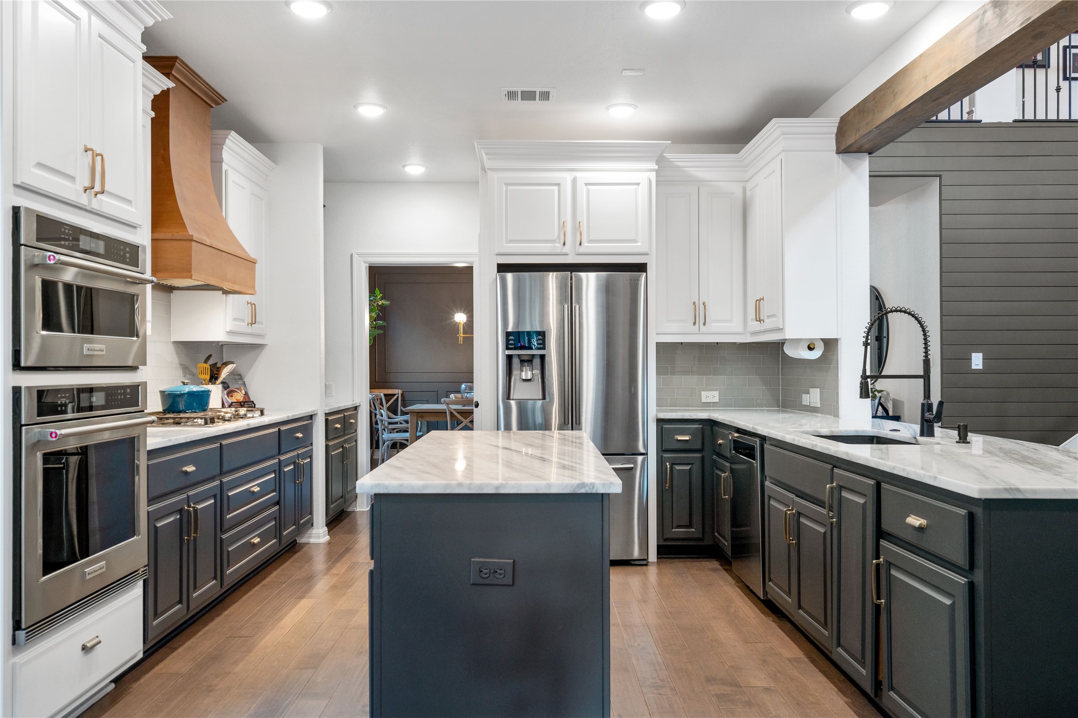 2829 Long Lasso Pass Leander, TX 78641 - Photo 12 of 40 a large kitchen with stainless steel appliances granite countertop a sink stove refrigerator and cabinets