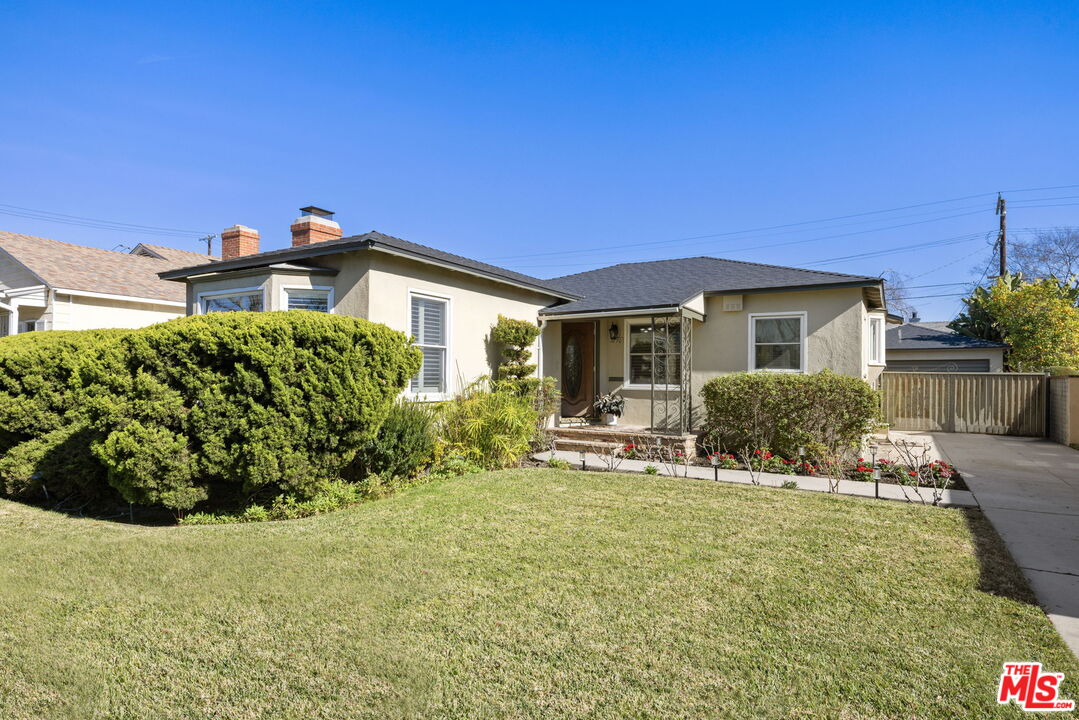 3770 Buckingham Road Los Angeles, CA 90016 - Photo 1 of 19 a view of a house with backyard sitting area and garden