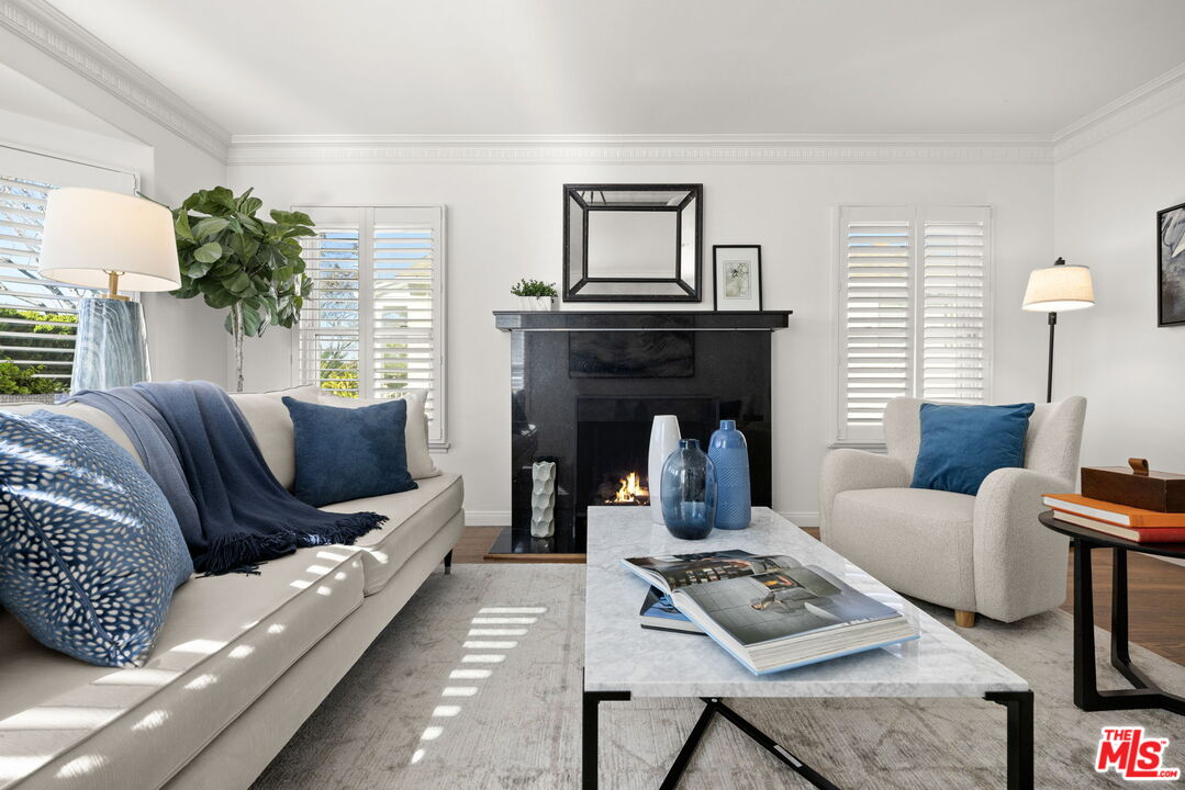 3770 Buckingham Road Los Angeles, CA 90016 - Photo 2 of 19 a living room with furniture a lamp and a fireplace