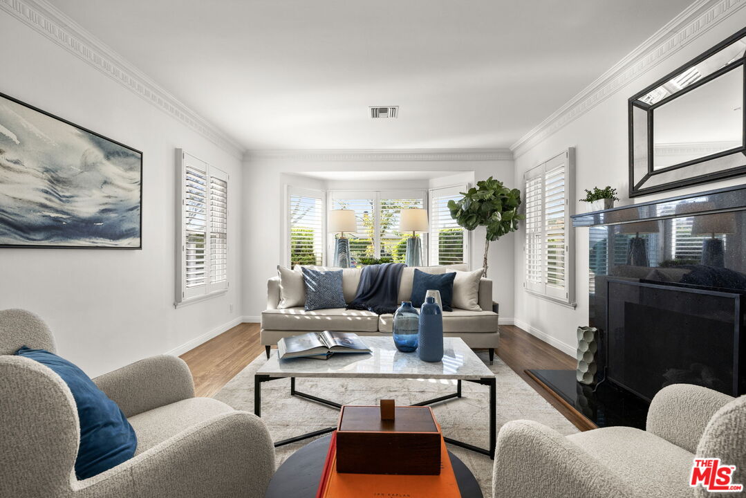 3770 Buckingham Road Los Angeles, CA 90016 - Photo 3 of 19 a living room with furniture potted plant and a window