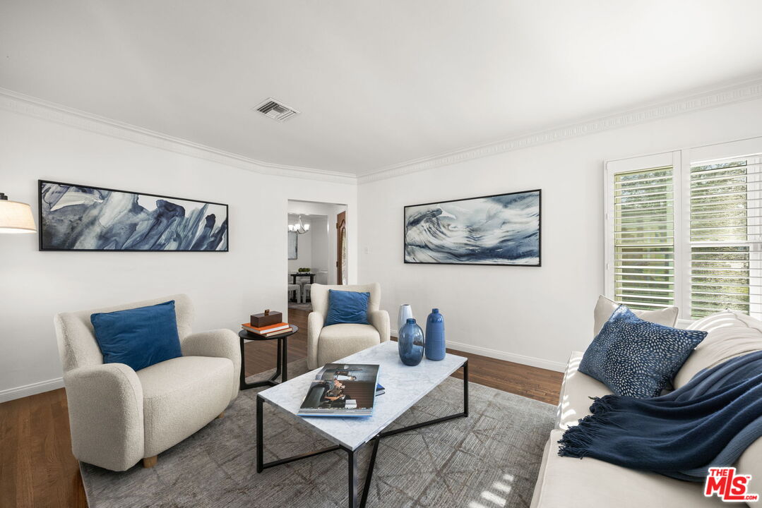 3770 Buckingham Road Los Angeles, CA 90016 - Photo 4 of 19 a living room with furniture a rug and a window