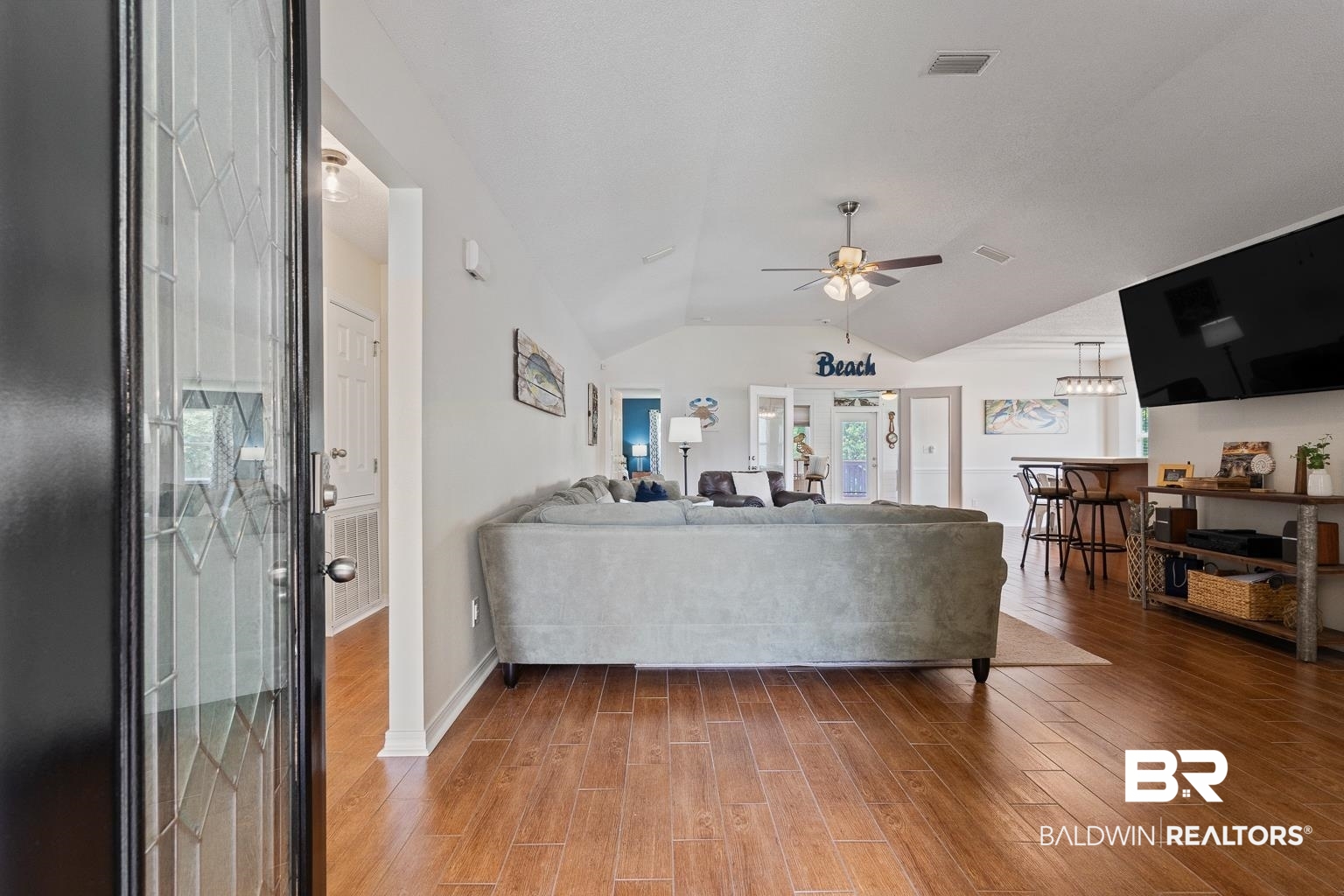 22764 Respite Lane Foley, AL 36535 - Photo 14 of 46 Living room with ceiling fan, lofted ceiling, light wood-type flooring, and baseboards