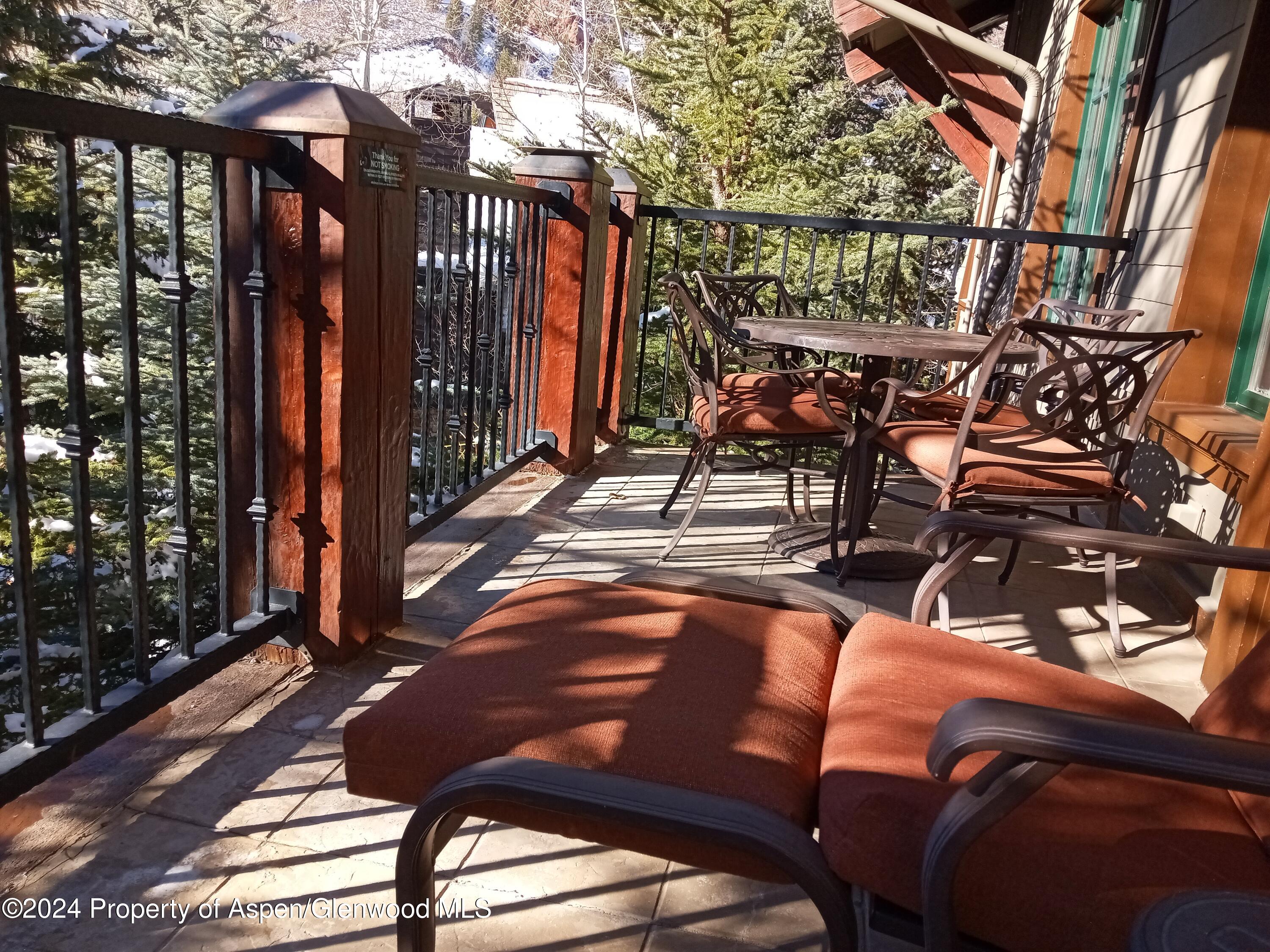 75 Prospector Road, Unit 8206 SUMMER INTEREST 7 Aspen, CO 81611 - Photo 16 of 21 a view of a chairs and table in the patio