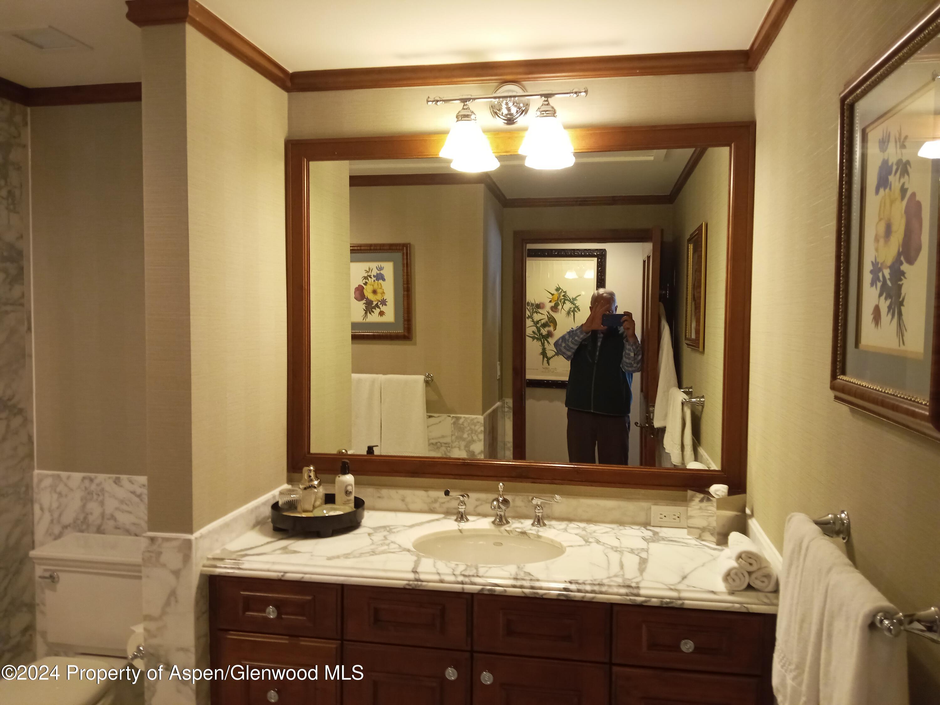 75 Prospector Road, Unit 8206 SUMMER INTEREST 7 Aspen, CO 81611 - Photo 10 of 21 a bathroom with a granite countertop sink and a mirror