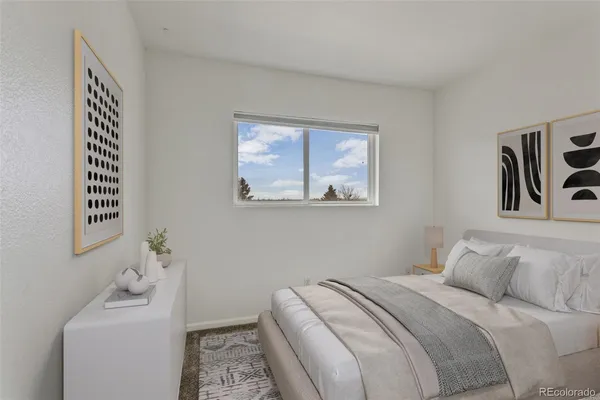 a bedroom with a bed and a table