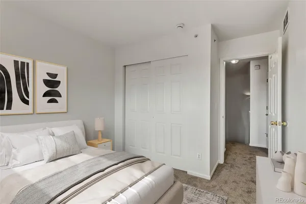 a bedroom with a bed and a couch