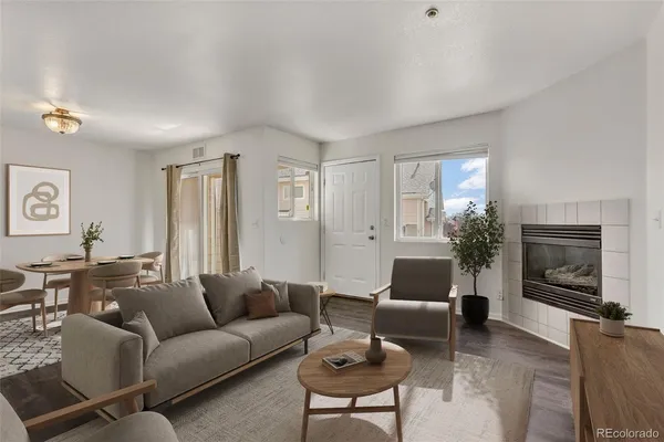 a living room with furniture a flat screen tv and a window