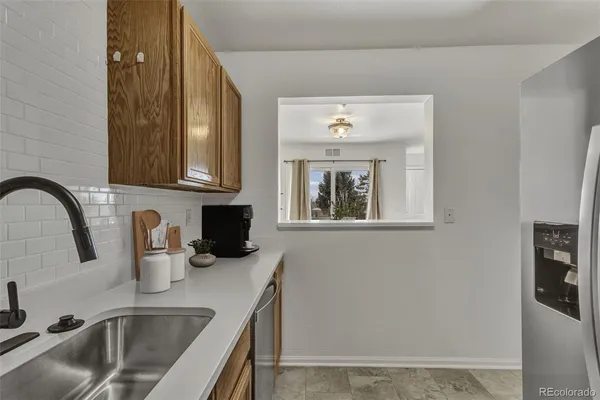 a kitchen with a sink cabinets and a window