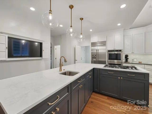a kitchen with a sink a microwave and cabinets