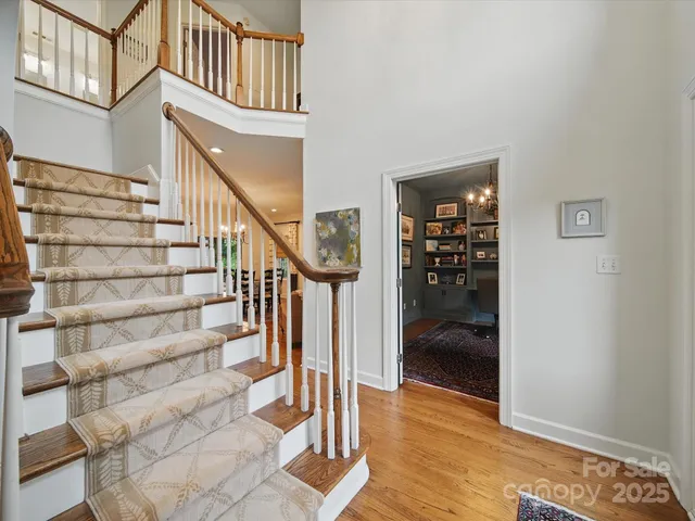 a view of entryway and hall with wooden floor