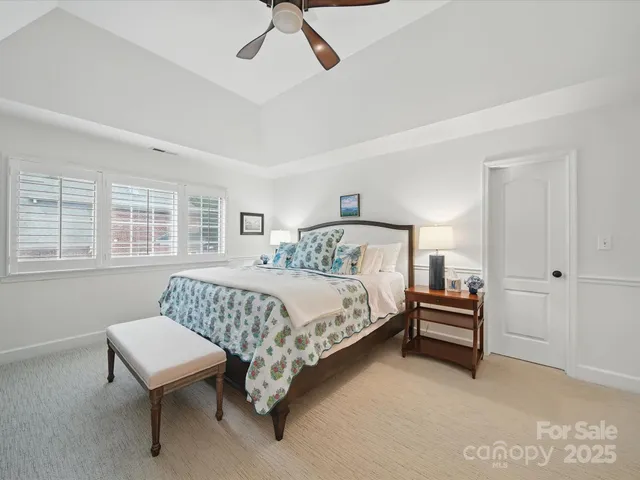 a bedroom with a bed chair and window