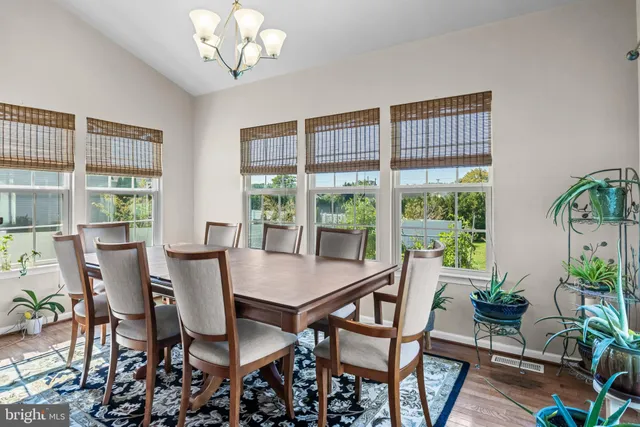 a living room with lots of furniture a fireplace and kitchen view