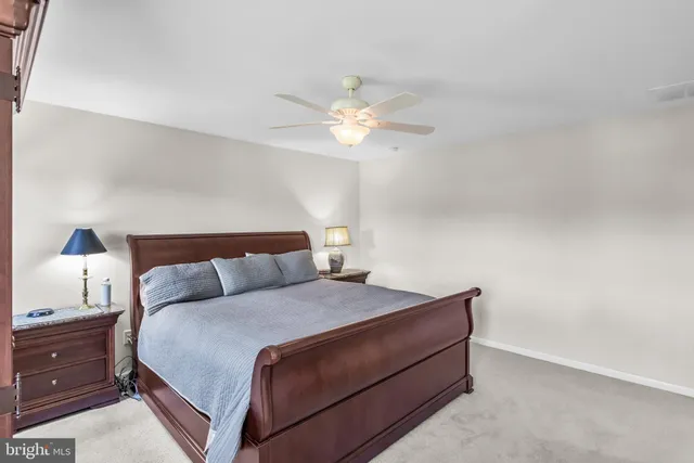 a bed sitting in a bedroom next to a window with a dresser