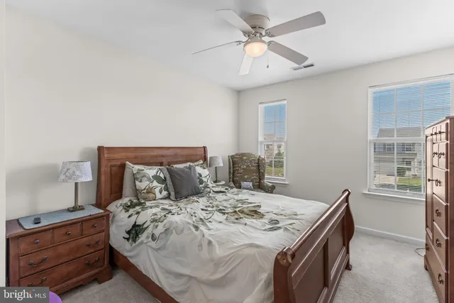 a front view of a house with a yard table and chairs