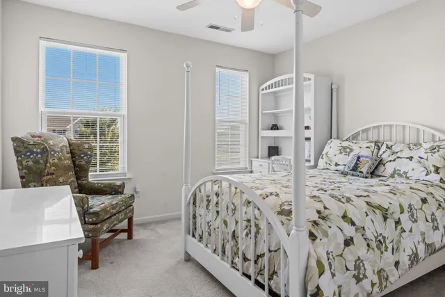 a view of a green field with house in the background