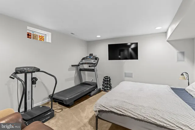 an aerial view of a house with swimming pool and tennis court