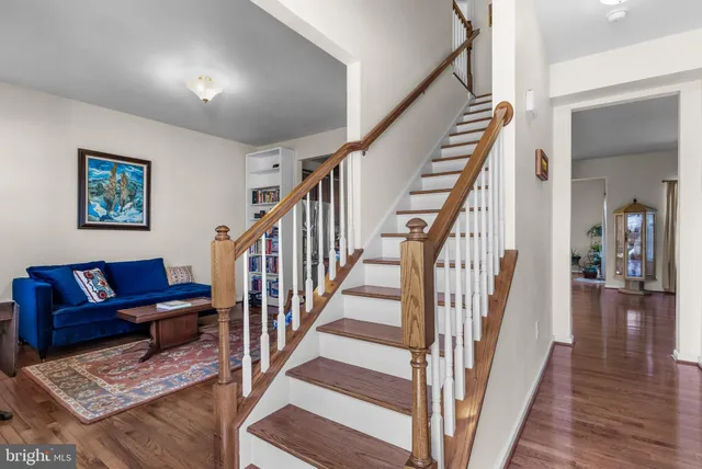 a view of staircase with wooden floor and a rug
