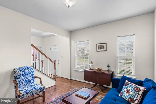 a kitchen with a refrigerator a stove a sink and a cabinets with wooden floor