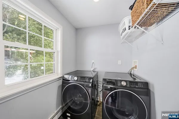 a view of storage and utility room with washer and dryer