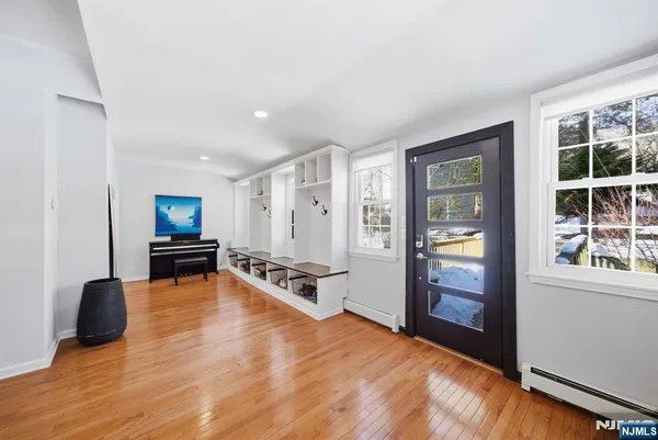 a living room with furniture a flat screen tv and large window