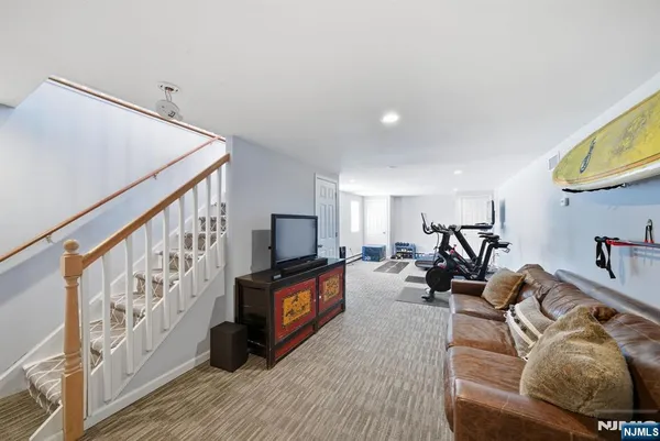 a living room with furniture windows and a flat screen tv