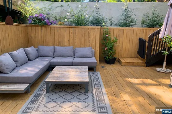 a view of a house with wooden deck and backyard