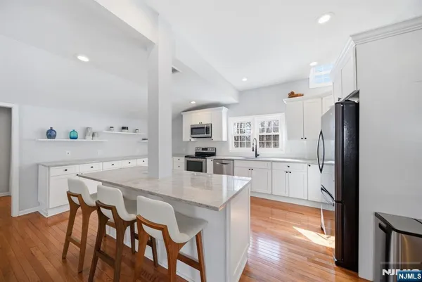 a large kitchen with a table and chairs